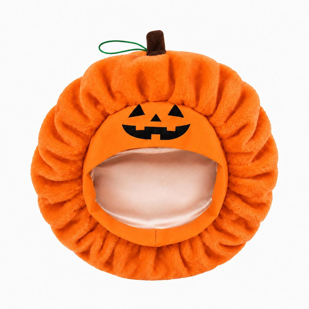 GhoulGoods plush pumpkin sleep cap in orange, flat lay showing the jack-o'-lantern face and the black elastic rope toggle